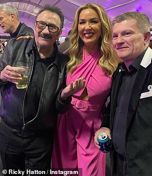 Claire, dressed in a bright pink jumpsuit, placed her arm comfortably on Ricky's shoulder as the couple settled in for the photo (left to right: Paul Elliott, Claire and Ricky).