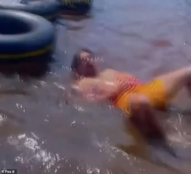 The video then shows the chilling moment when another member of the group falls into the river as a pool of red water emerges around them.