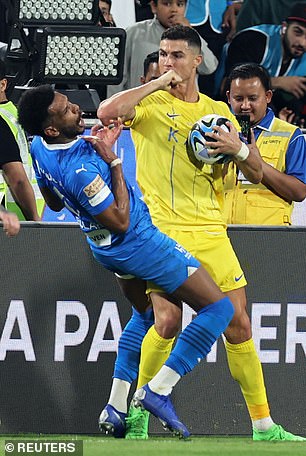 Ali Al-Bulaihi, of Al-Hilal, falls to the ground after receiving an elbow from Ronaldo