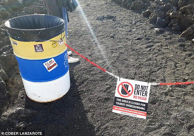 Fake signs reading 'closed due to overcrowding' have been put up at the island's popular beauty spas, as environmentalists say Lanzarote is being ruined by its own success.