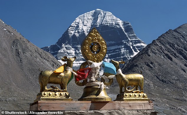 Dharmachakra, the main Buddhist symbol, on the roof of Dirapuk Buddhist Monastery, with the north face of Mount Kailash in the background
