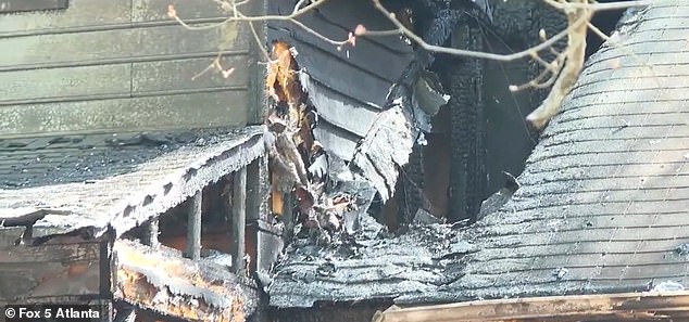 The roof of the house is seen collapsed and charred after the intense fire took hold.  One firefighter was injured and taken to hospital for treatment.