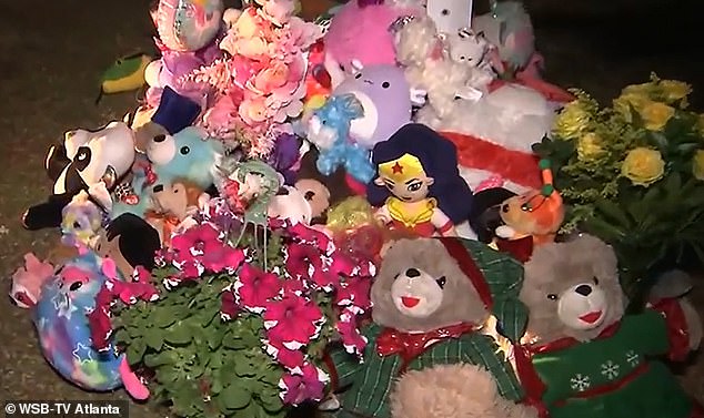 Outside the charred house, friends and family set up a memorial filled with stuffed animals and flowers.