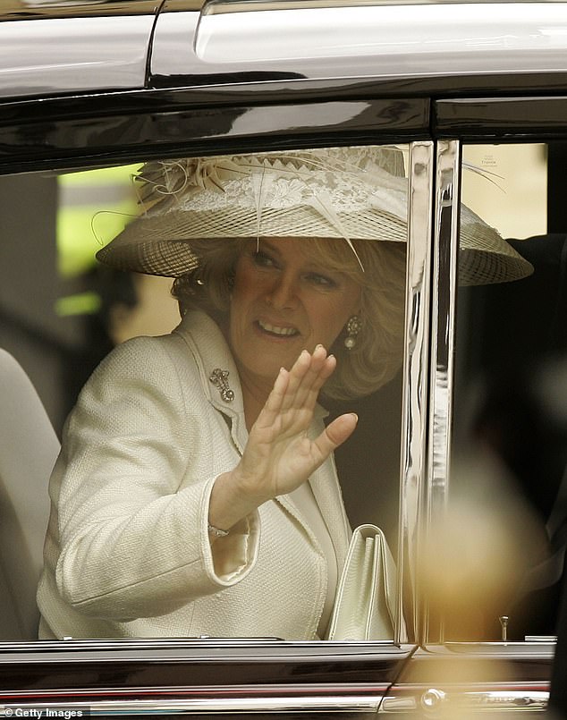Queen Camilla is pictured waving to the crowd on her wedding day in April 2003. The couple became Duke and Duchess of Cornwall after their marriage.