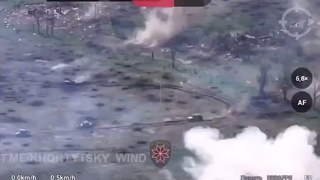 Another video, this time apparently taken from a drone, shows three Russian tanks with their covers lumbering across a battlefield in the Ukrainian-controlled city of Krasnohorivka while coming under fire.