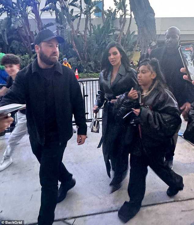 The reality star, 43, and her mini-me, 10, matched in black looks, with Kim sporting a sleek Matrix-style black coat cinched at the waist with a belt.