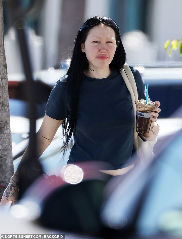 While walking around Los Angeles on Tuesday, the 24-year-old singer put her numerous tattoos on display while modeling a navy crop top paired with a pair of baggy black sweatpants.