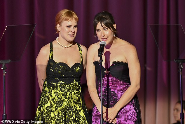 The sisters appeared to be presenting at the ceremony, as they were photographed smiling side by side into a microphone on stage.
