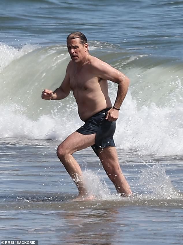 Despite looming federal tax charges, Hunter seemed unconcerned as he fled the cold waters of Malibu.