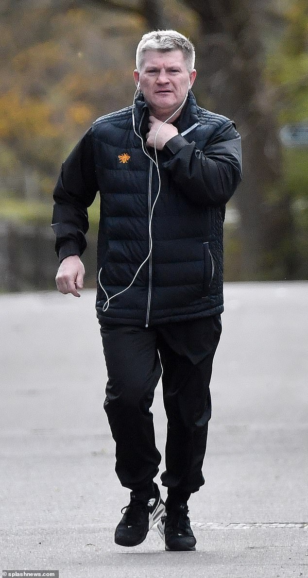 He looked in good spirits as he did some light exercise in the park and listened to some music with his headphones on.