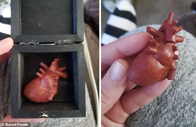 Someone received this in the mail a few days after Valentine's Day.  The black box was sealed, but after they opened it with a knife there was a mini wooden heart inside.