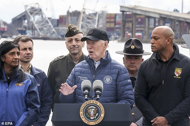President Joe Biden (C) delivers a speech near the remains of the Francis Scott Key Bridge, in the background, with Maryland Governor Wes Moore, right.