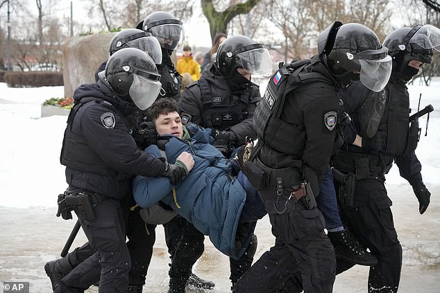 FILE - Police detain a man who wanted to lay flowers in honor of Russian opposition leader Alexei Navalny in St. Petersburg, Russia, Saturday, February 17, 2024.