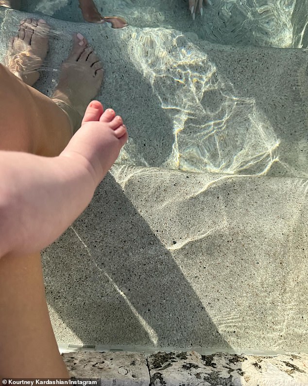 While on vacation with her family, including sisters Kim and Khloé Kardashian, in Turks and Caicos, the 44-year-old reality star posted an adorable snap of her little one sitting on her lap while they both dipped their feet in the pool.
