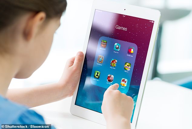 A child's addiction to devices could be a warning that they are already vulnerable to mental illness (file image)