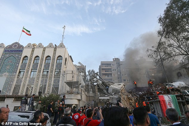 Emergency and security personnel search through rubble at the site of attacks that hit a building attached to the Iranian embassy in the Syrian capital, Damascus, on April 1, 2024.