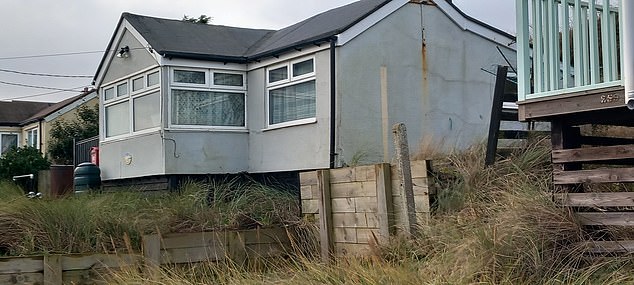 His house (pictured) on the Norfolk coast had to be demolished by the council due to the risk of marine erosion.