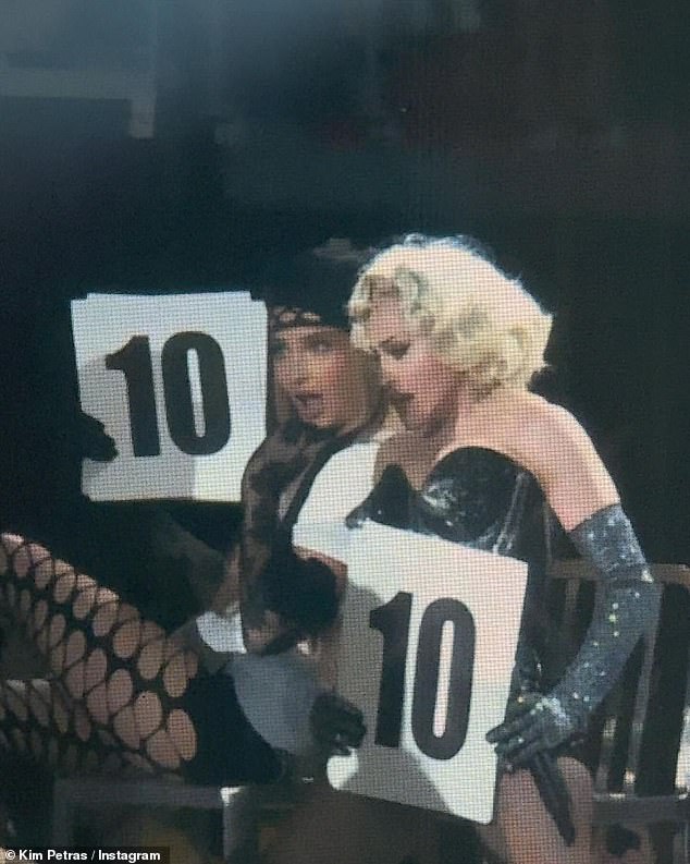 The duo, sitting side by side, held signs with the number 10 as they rated scantily clad dancers on the stage catwalk.