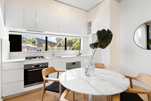 Danika's investment apartment features a modern stone gas kitchen with built-in dishwasher, as well as an open-plan lounge and dining room.