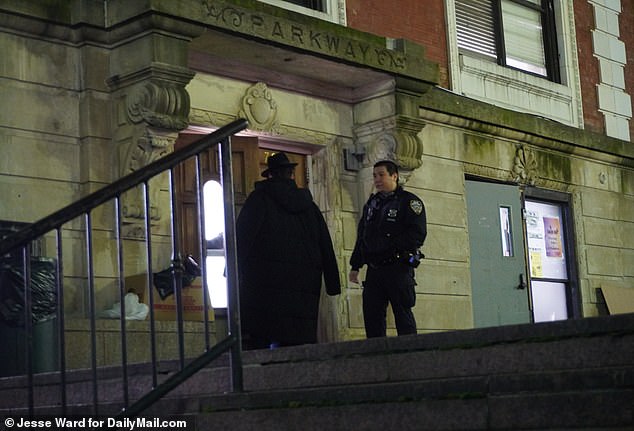 An NYPD officer is seen speaking with a community member.