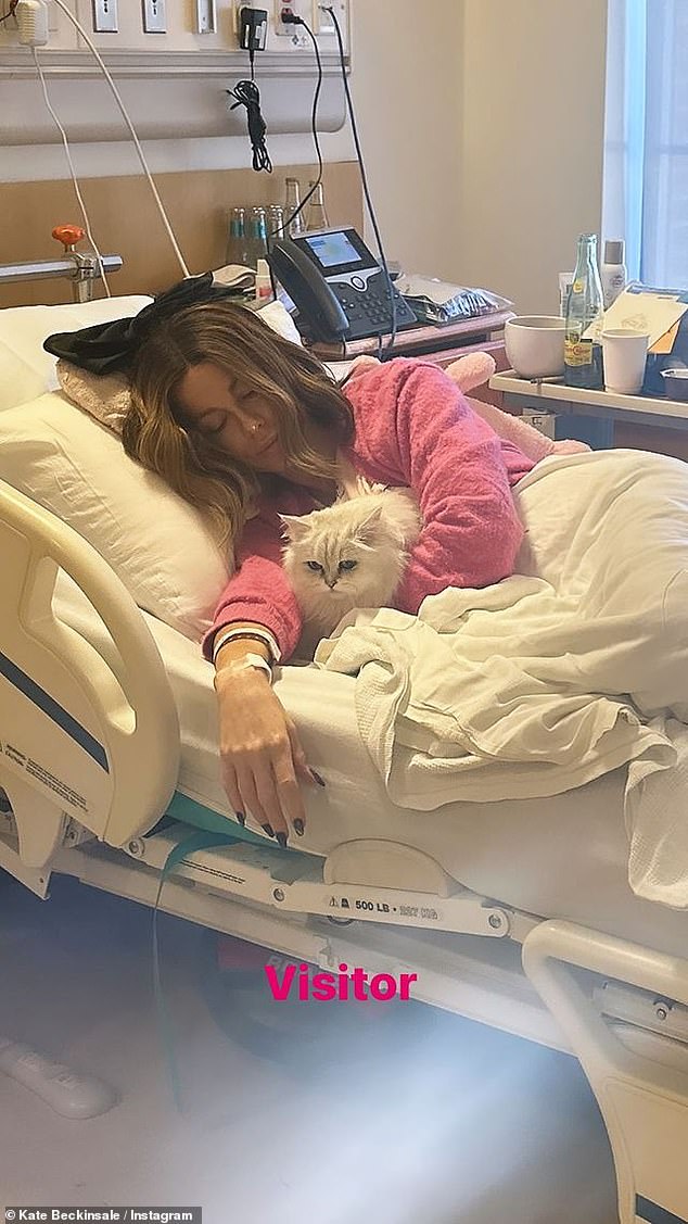 After first looking sombre in a hospital gown and a big bow on her head on March 11, Mother's Day in the UK, she shared a cute photo of herself with her cat Willow the next day.