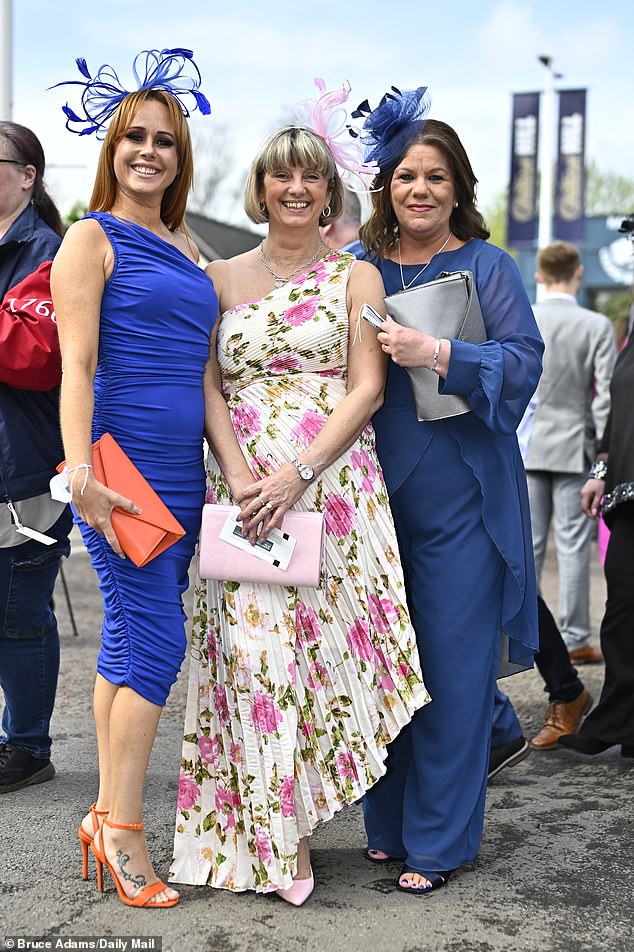 Three times more pleasant!  These stunning racegoers were clearly dressed to impress in their high heels and flattering dresses.