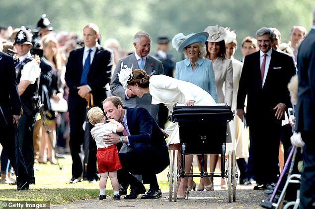 Doting father William comforts young George as his in-laws, the Middletons, look on in 2015