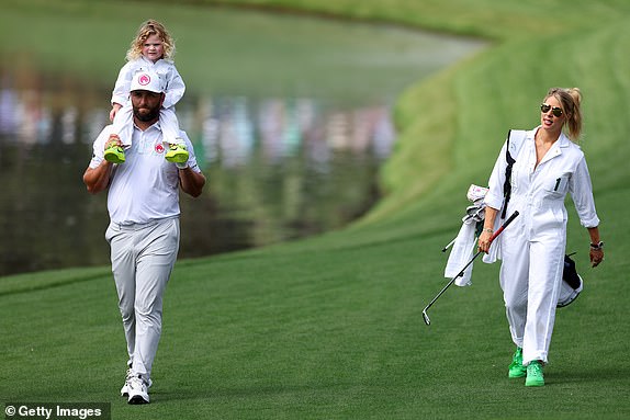 AUGUSTA, GEORGIA - APRIL 10: Jon Rahm of Spain holds his son, Kepa, and walks with his wife, Kelley Cahill, during the par three contest before the 2024 Masters Tournament at Augusta National Golf Club on April 10, 2024 in Augusta, Georgia. (Photo by Andrew Redington/Getty Images)