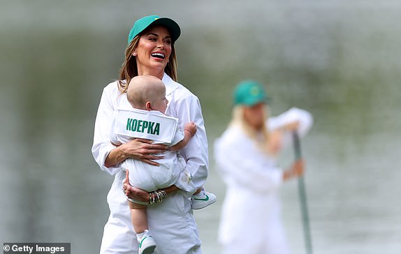 AUGUSTA, GEORGIA - APRIL 10: American wife Brooks Koepka, Jena Sims, holds his son, Crew, during the par three contest ahead of the 2024 Masters Tournament at Augusta National Golf Club on April 10, 2024 in Augusta, Georgia. (Photo by Andrew Redington/Getty Images)