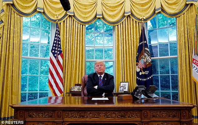 Trump, pictured here in the Oval Office, has indicated that he is interested in spending more than eight years at the Resolute desk.