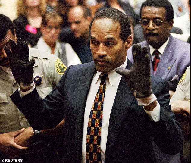 OJ Simpson holds blood-stained gloves found by Los Angeles police during part of his murder trial in 1996. Simpson died Wednesday at the age of 76.