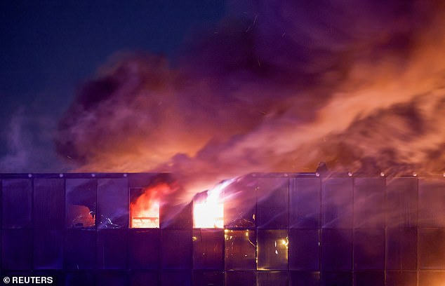 Fire smoke rises over the burning Crocus City Hall concert venue following a shooting, outside Moscow, Russia, on March 22.