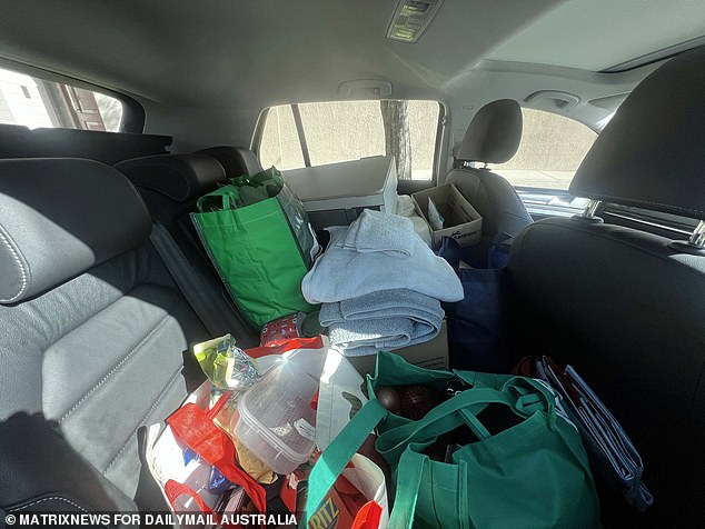 The back of Mr Lehrmann's car was packed with his belongings on the street elsewhere in Sydney, including plenty of towels and food such as Ritz crackers.