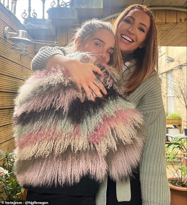 Helen enjoyed a cuddle with her friend Libby while wearing a stunning multi-coloured pastel coat.