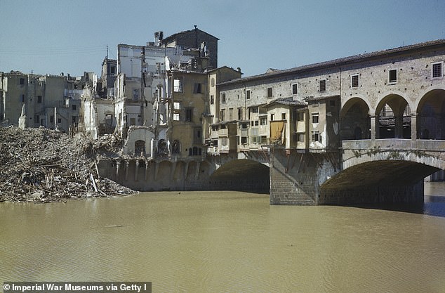 Pictured: A colorized image of the damage around the Ponte Vecchio bridge over the Arno River, in Florence, Italy, during World War II.