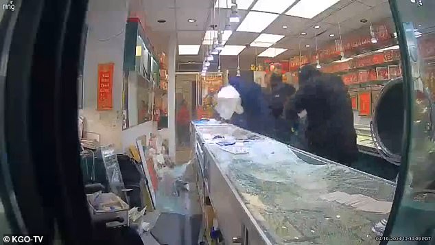 Diane and another woman duck and run to leave the room as the robbers continue to loot the store.