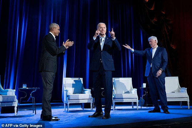 Former President Barack Obama (left) and former President Bill Clinton (right) cheer on President Joe Biden (center) during a campaign fundraiser at Radio City Music Hall.