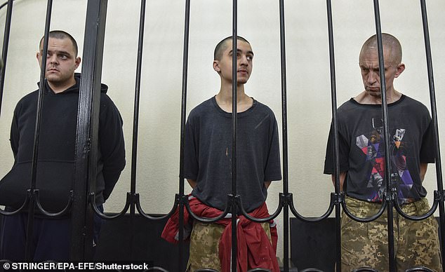 British citizens Aiden Aslin (L) and Shaun Pinner (R) and Moroccan Saaudun Brahim (C) attend a sentencing hearing at the Supreme Court of the self-proclaimed Donetsk People's Republic (DPR) in Donetsk, eastern Ukraine, on June 9, 2022.