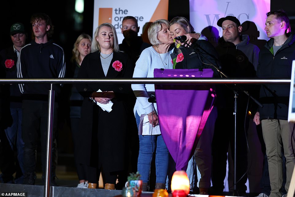 Rebecca Young's family are seen comforting each other at the rally in Ballarat on Friday night.