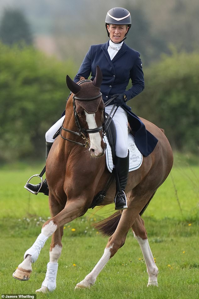 Pairing a smart navy double-breasted jacket with white jodhpurs, the Princess Royal's daughter, 42, looked like she meant business as she elegantly made her way along the stunning course.