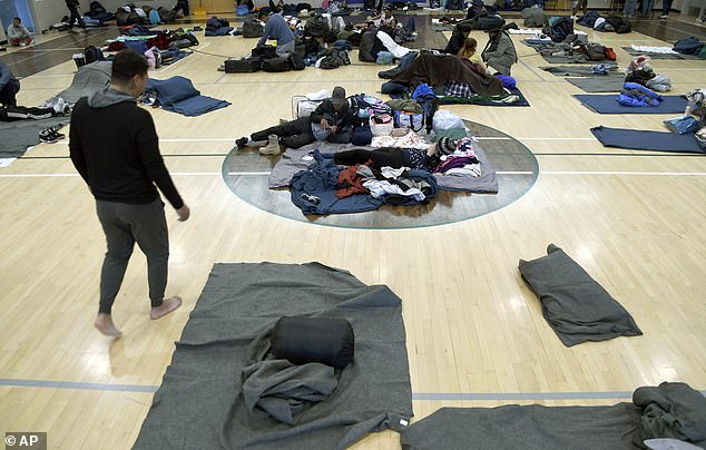 The amount will be drawn from approximately $45 million that is used for public programs and services (Migrants rest in a makeshift shelter, January 6, 2023, in Denver)