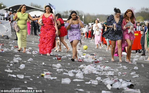 Rubbish strewn on the ground on Ladies Day at Aintree Racecourse in Liverpool