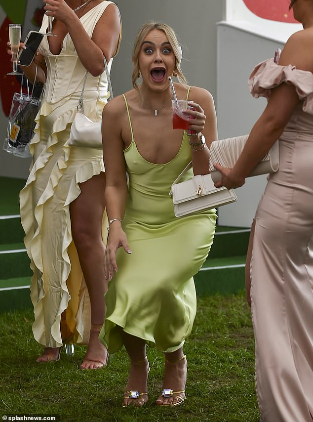 Today a group of friends are shown having fun in Aintree, while a woman smiles at the camera with a drink in her hand.