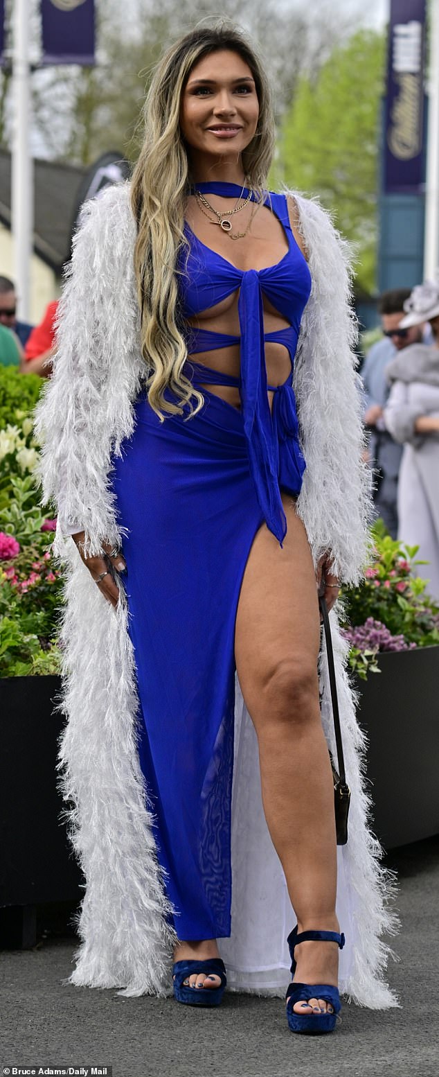 This reveler wore a sapphire blue dress with a high thigh-high slit, paired with a fluffy coat.