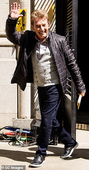 Martin Short, who plays Broadway director Oliver Putnam, also waved to the crowd while sporting a gray double-breasted vest and dress shirt under a quilted coat.
