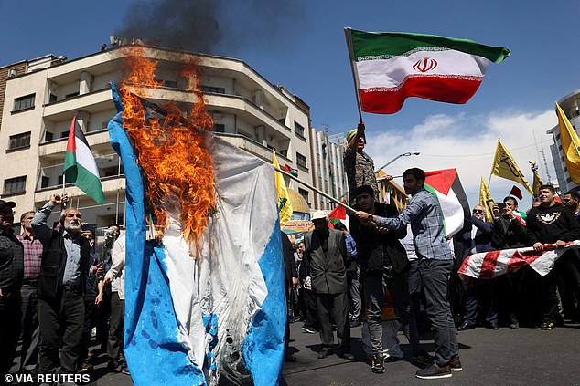 Protesters in Tehran burn an Israeli flag after members of the Islamic Revolutionary Guard Corps were killed in a suspected Israeli attack. That led the US to warn of a possible Iranian attack on Israel.