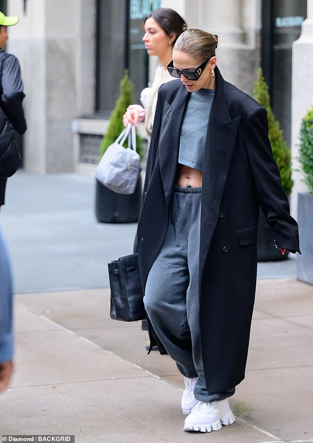For her latest outing, the 54-year-old superstar kept it casual as she rocked a long black coat, matching Dior sunglasses, white sneakers, and gold hoop earrings.