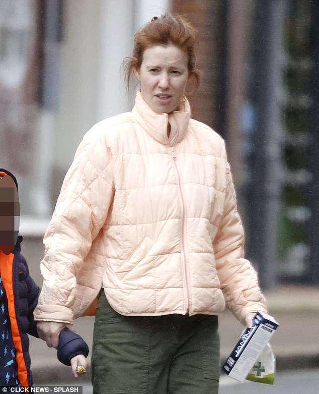 Amy, who appeared makeup-free, embraced her natural look as she swept her red locks out of her face while running errands with the couple's son.