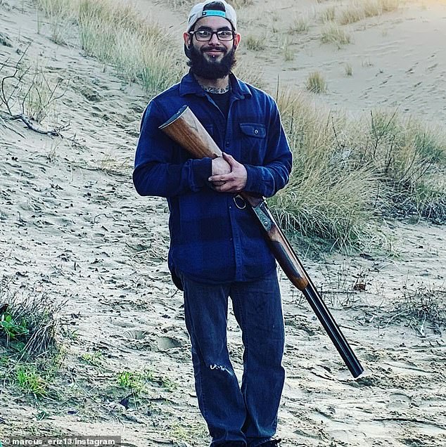 Eriz is seen in a social media photo holding a rifle. The 27-year-old auto worker's social media accounts are littered with photos of him with firearms.
