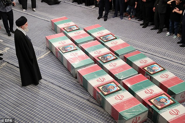 A photograph provided by the Iranian Supreme Leader's office shows Iranian Supreme Leader Ayatollah Ali Khamenei praying at the coffins of members of the Iranian Revolutionary Guard Corps (IRGC) who were killed in Syria.